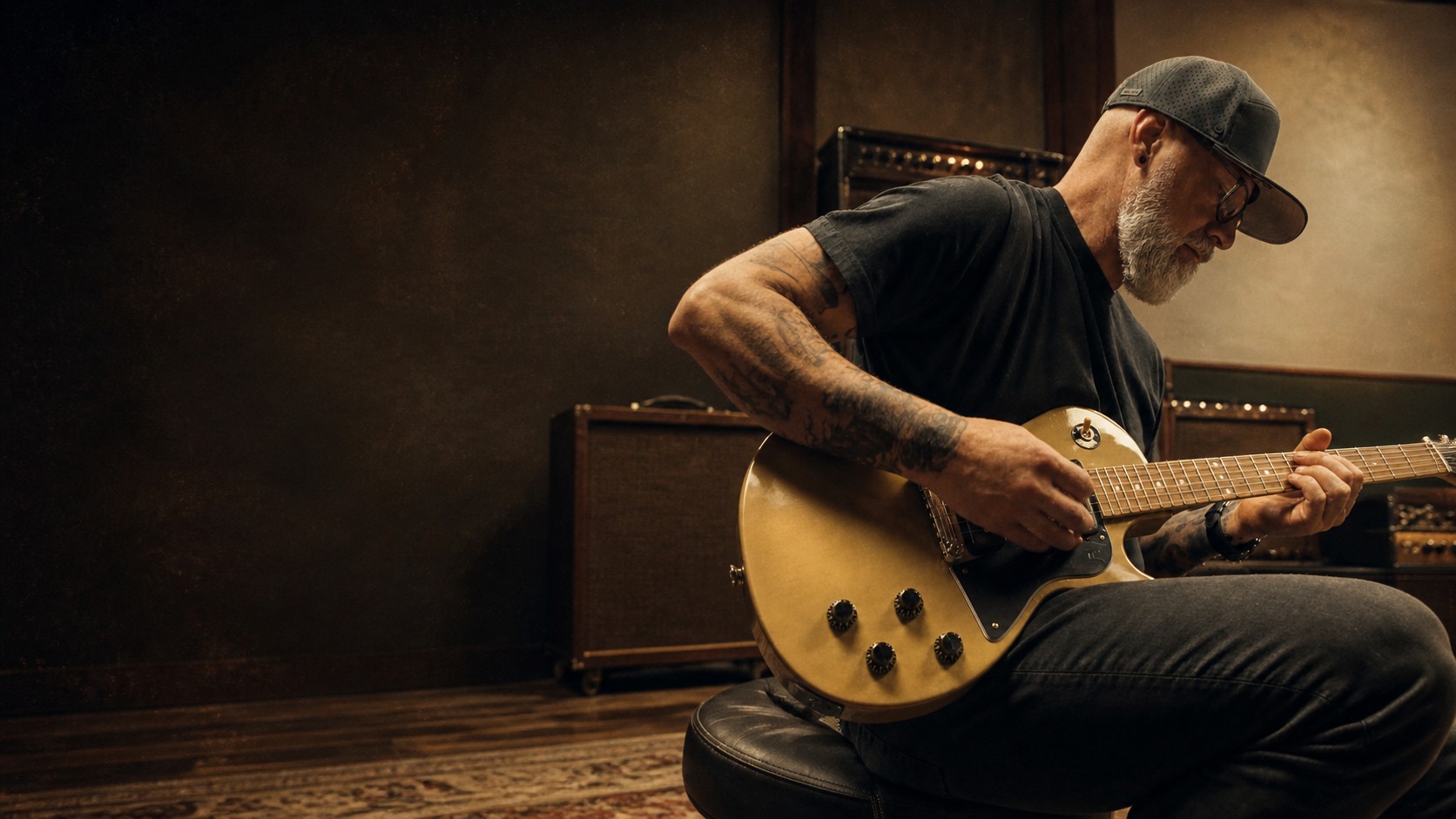 Matthew Sloan Wallace playing a TV-yellow Gibson Les Paul Special in a room at Detroit Guitars, walnut amplifier cabinets behind him.